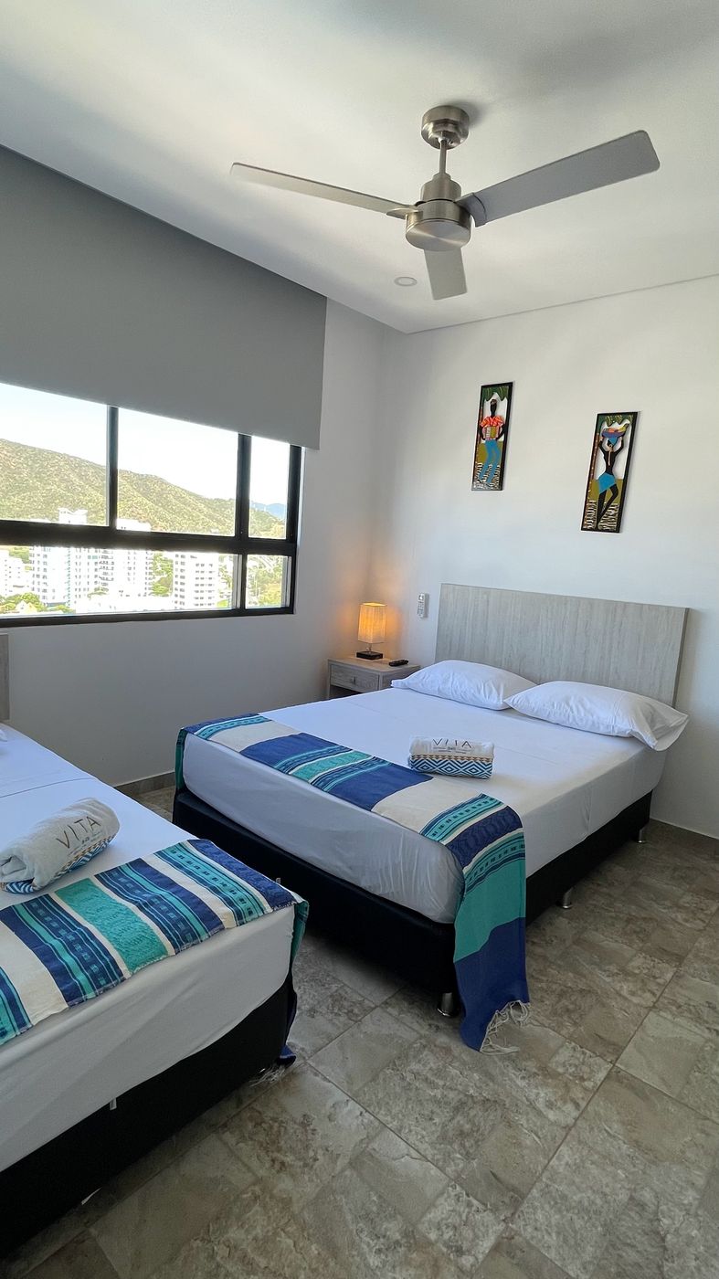 Bedroom with double and single beds in a Santa Marta El Rodadero apartment rental